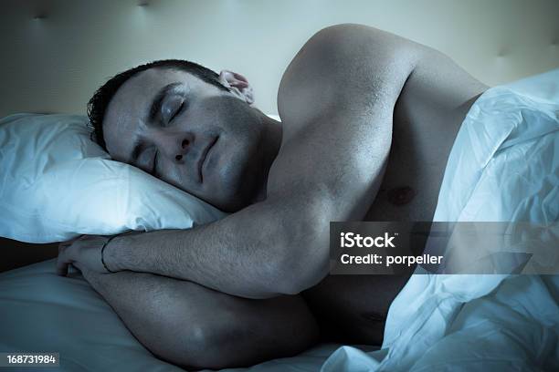 A Man Sleeping Comfortably In His Bed Stock Photo - Download Image Now - Men, Sleeping, Muscular Build