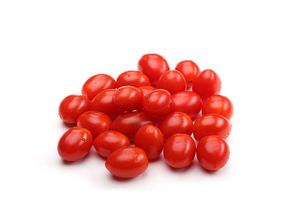 handful of plum tomatoes stock photo