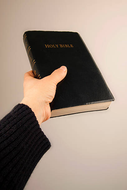 istock Hand giving the Bible 168732854