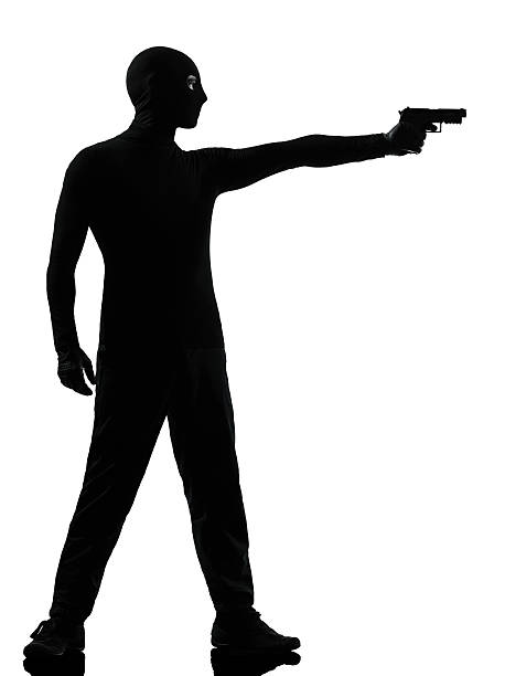 istock thief criminal terrorist aiming gun man 168732962