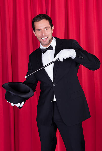 istock Happy Magician In Black Suit 168733090