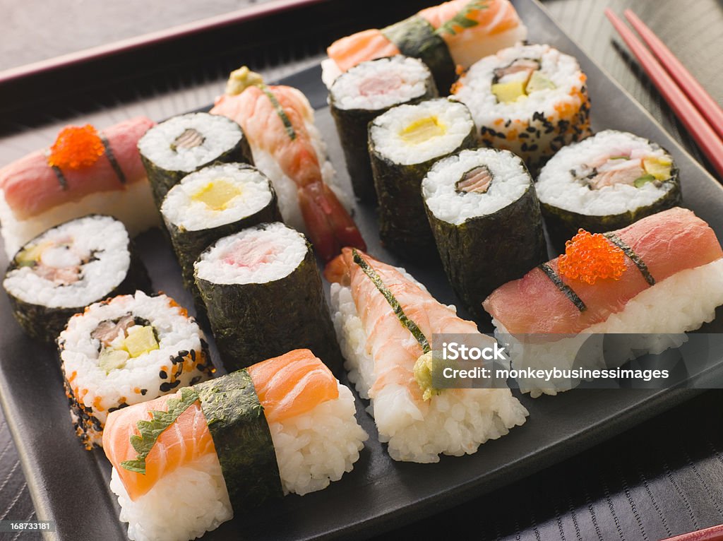 Selection of Seafood and Vegetable Sushi on a Tray Selection of Seafood and Vegetable Sushi on a Tray with chopsticks Asian Food Stock Photo