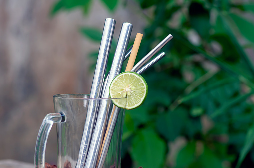 Bamboo and steel straws, an alternative to reducing plastic straws. The concept of reducing non-degradable plastic waste.