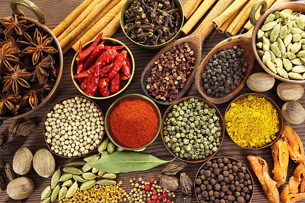 Spices Spices and herbs in metal  bowls and wooden spoons. Food and cuisine ingredients. spice stock pictures, royalty-free photos & images