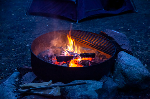Fire ring with logs burning in the evening at a Minnesota state forest campground