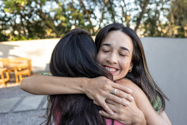istock Happy latin women hugging each other 1687425203