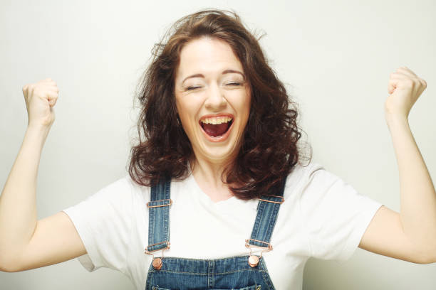 istock woman happy ecstatic celebrating being a winner. 1687438971