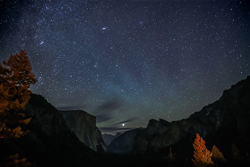 The view of valley with starry sky at the Tunnel View of Yosemite National Park, with Jupiter above the Half Dome