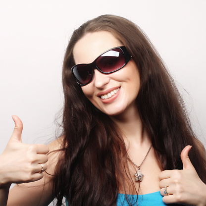 portrait of happy woman showing thumbs up