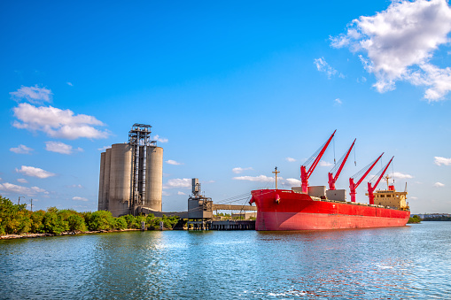 An international bulk carrier cargo ship in port at grain silos along the Buffalo Bayou on the Houston Shipping Channel about 4 miles east of downtown Houston, Texas.