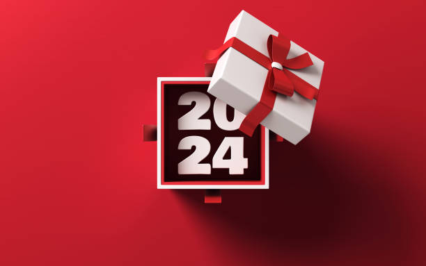 2024 Coming Out Of A White Gift Box Tied With Red Ribbon stock photo 2024 is coming out of a white gift box tied with red ribbon on red background. Horizontal composition with copy space. Directly above. Great use for Christmas related gift concepts. unwrapping stock pictures, royalty-free photos & images