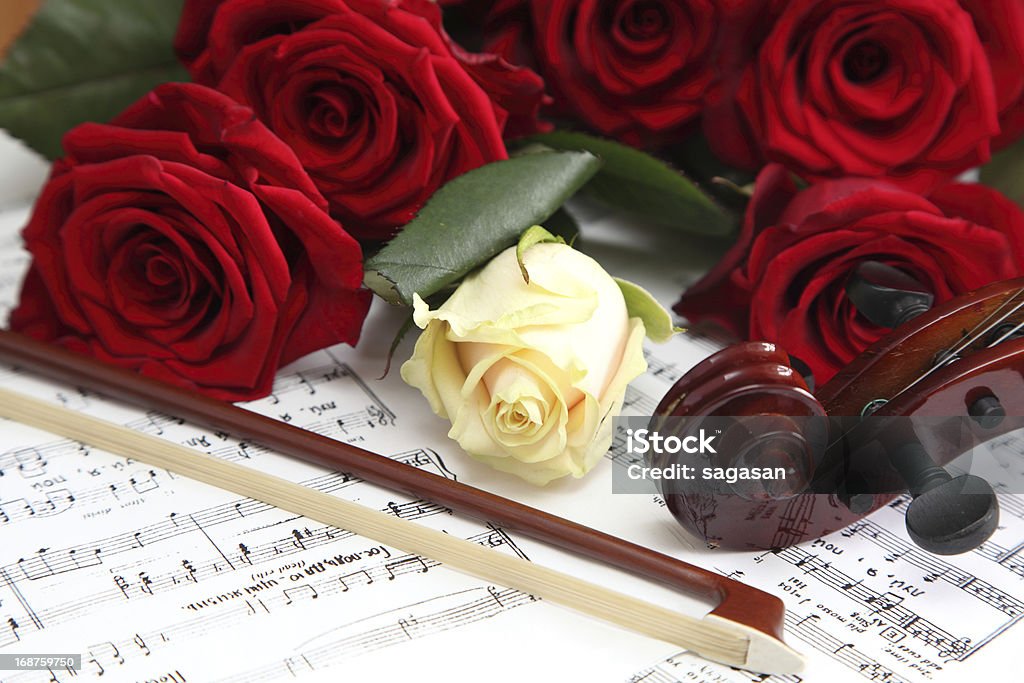 red and white roses red and white roses on a sheet with notes Horizontal Stock Photo