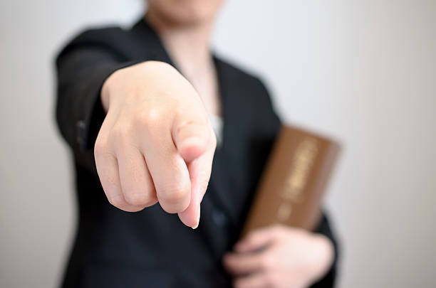 finger pointing by female with book stock photo