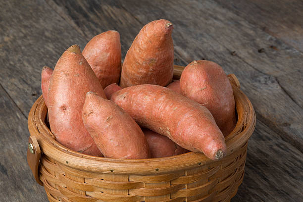 istock Sweet Potatoes in Basket on Wood Table 168763074