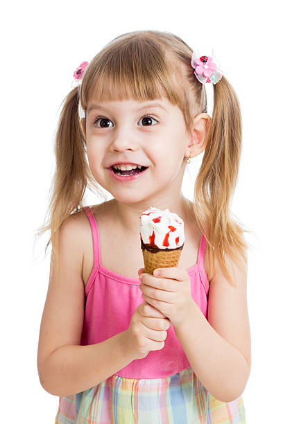 istock happy child girl eating ice cream in studio 168763209