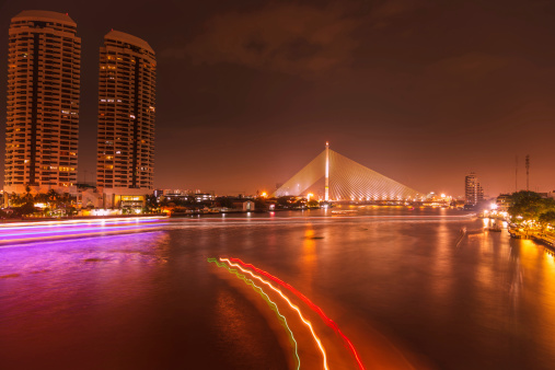 Overlooking Chao Phraya River in Bangkok, Thailand at night.