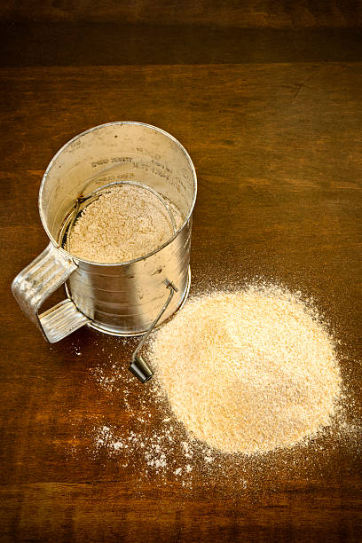 istock Whole Wheat Flour and Old Sifter on Rustic Table 168763658