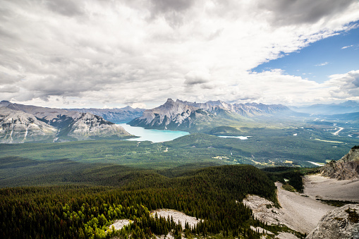 An expansive view over a valley with Lake Minnewanka.
