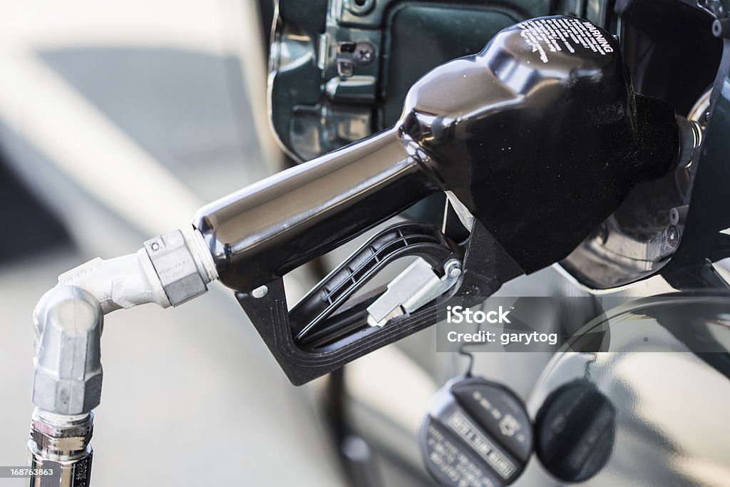 Fill Up A close up of a gas pump filling up a green pickup truck. Fuel consumption. Energy Use. Fuel Pump Stock Photo