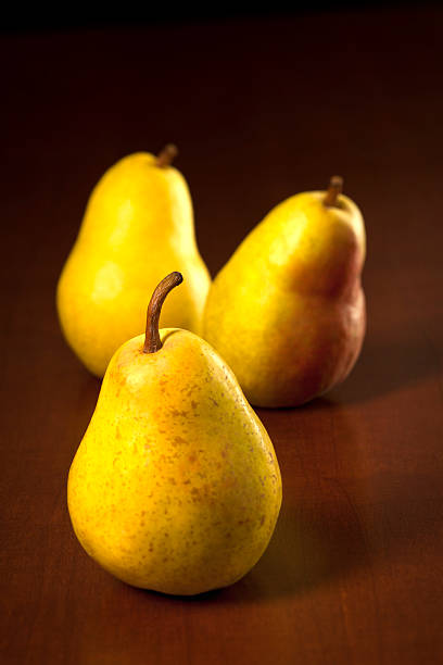 istock Golden Bartlett Pears on Dark Wooden Table 168763943