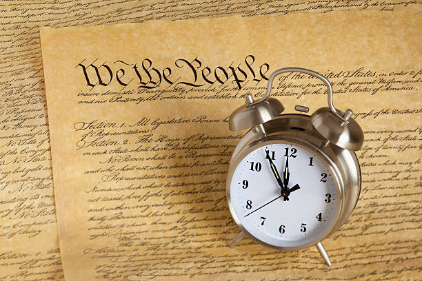 istock Alarm Clock Sitting on US Constitution - We The People 168765674