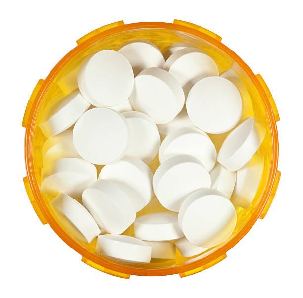 Prescription Medicine Bottle Filled With White Tablets From Above stock photo