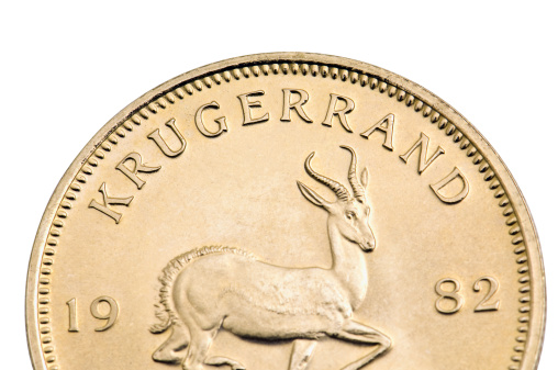 A straight stack of 11 Krugerrand  gold coins on white background