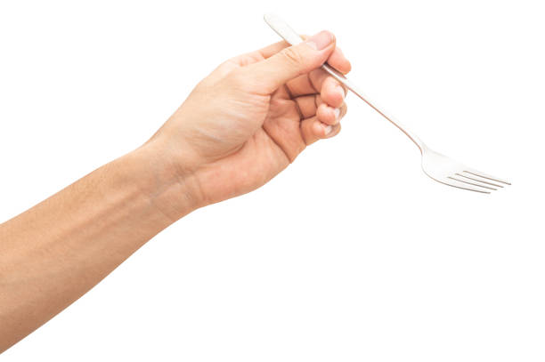 istock isolated of a man's hand holding a silver steel fork. 1687677645