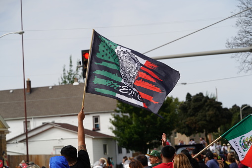 Milwaukee, Wisconsin USA - September 16th, 2023: Latino American families gathered along the streets to watch and spectate the Mexican Independence Day Parade.