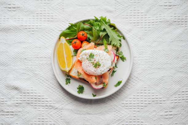 istock Breakfast toast, cucumber, salmon, poached eggs, and vegetables. 1687688825