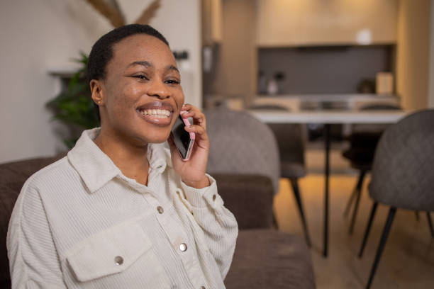 istock Happy young woman using phone 1687698012