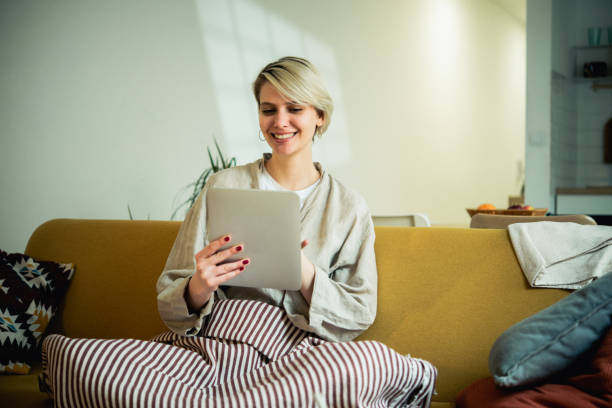istock Young woman using digital tablet at home 1687701804