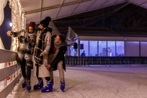 istock Three young friends ice skating together 1687707684