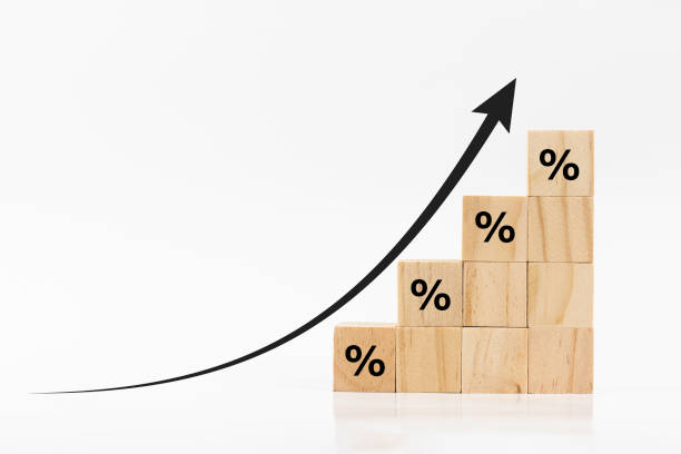 istock Stack wooden blocks with percentage symbol and arrow pointing up on white background. The economy is improving.Interest rate financial and mortgage rates concept. 1687713110