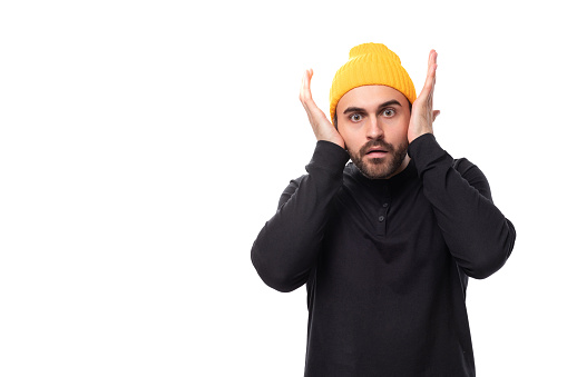 handsome 30s authentic brunet male adult in black sweatshirt posing as model on white background with copy space.