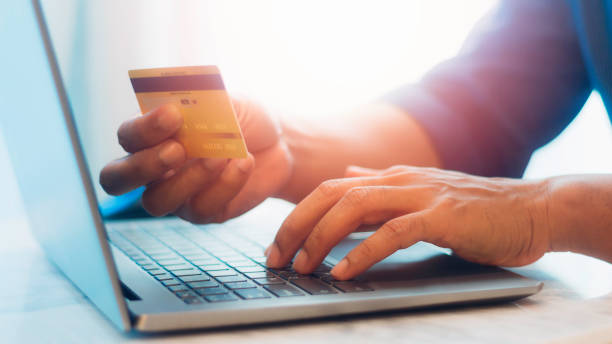 istock Hands holding credit card and using laptop. Digital money transfer, banking and e commerce concept. 1687714713