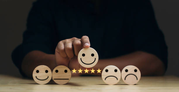 istock customer services best excellent business rating experience. Satisfaction survey concept. Businessman chooses a happiest smile on wood block circle. 5 Star Satisfaction. 1687716396