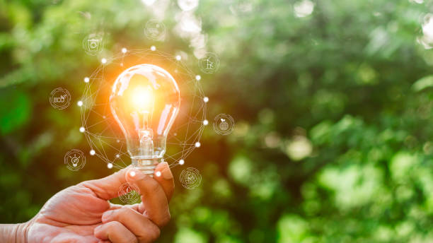 istock Hand holding light bulb with environment icons over the Network connection on nature background, Technology ecology concept. 1687717540