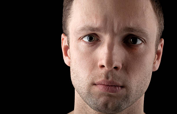istock Young Caucasian man's closeup portrait on black 168772789