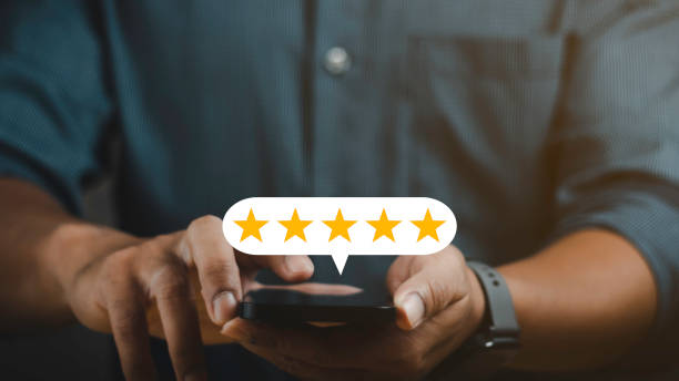 istock close up man hand using smartphone with popup five stars for feedback. Customer service experience and business satisfaction survey. 1687730502
