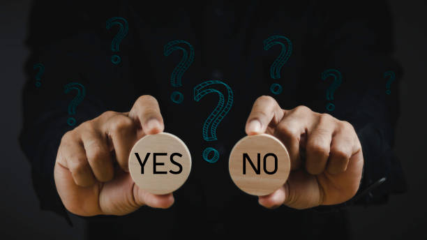 istock Think With Yes Or No Choice, Business Choices For Difficult Situations, Yes or no and question mark, man holding wooden with yes or no word on it, making decision. 1687731074