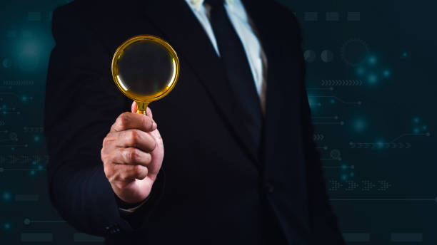 istock Businessman using magnifying glass for searching concept against graphic blue background. 1687756160