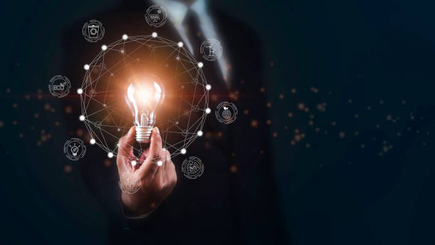 istock Businessman holding Bright light bulb with ecology concept against dark background. 1687757214