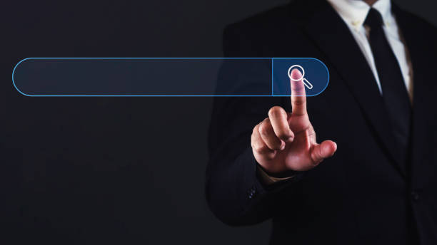 istock Businessman touching virtual search bar with empty space for text against dark background. 1687757743