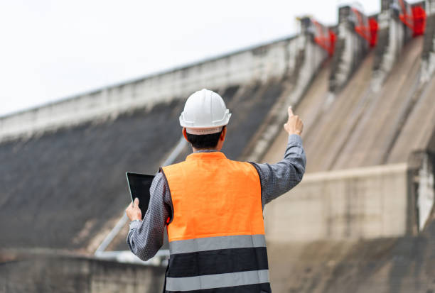 istock Professional asian maintenance engineer man with safety helmet in construction site dam with hydroelectric power plant and irrigation. Manager engineer man working with tablet at project big building. 1687771608