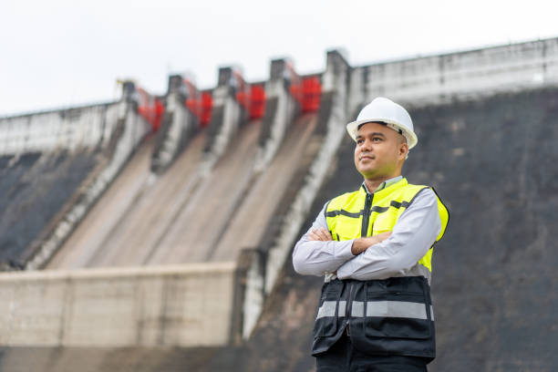 istock Professional asian maintenance engineer man with safety helmet in construction site dam with hydroelectric power plant and irrigation. Manager engineer man working at project big building. 1687771612