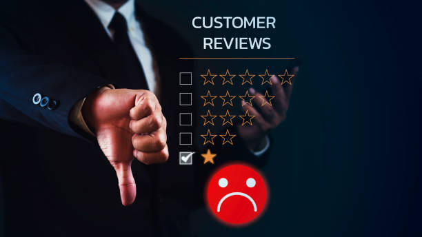 istock Businessman is using smartphone and showing thumb down for dissatisfied feedback review against dark blue background. 1687772141