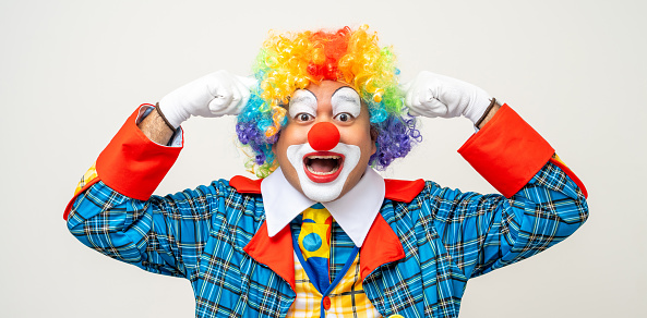 Mr Clown. Portrait of Funny face Clown man in colorful uniform standing and thinking. Happy expression male bozo in various pose on isolated background.