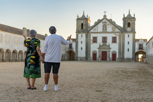 Elderly people pray in front of the church courtyard