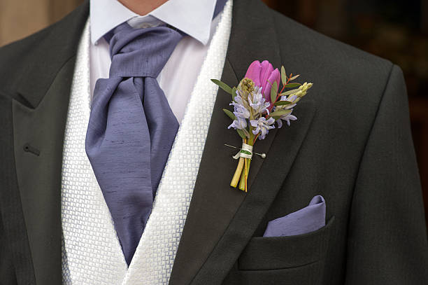 istock groom with purple flower buttonhole 168779324